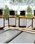 Four bottles of Angus & Florrie products on a wooden surface with a natural background.