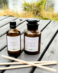 Two bottles of Angus & Florrie product on a wooden surface with a natural background