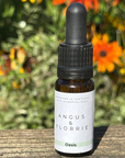 Bottle of Angus & Florrie essential oil with a natural background