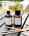 Two bottles of Angus & Florrie products on a wooden surface with a natural background