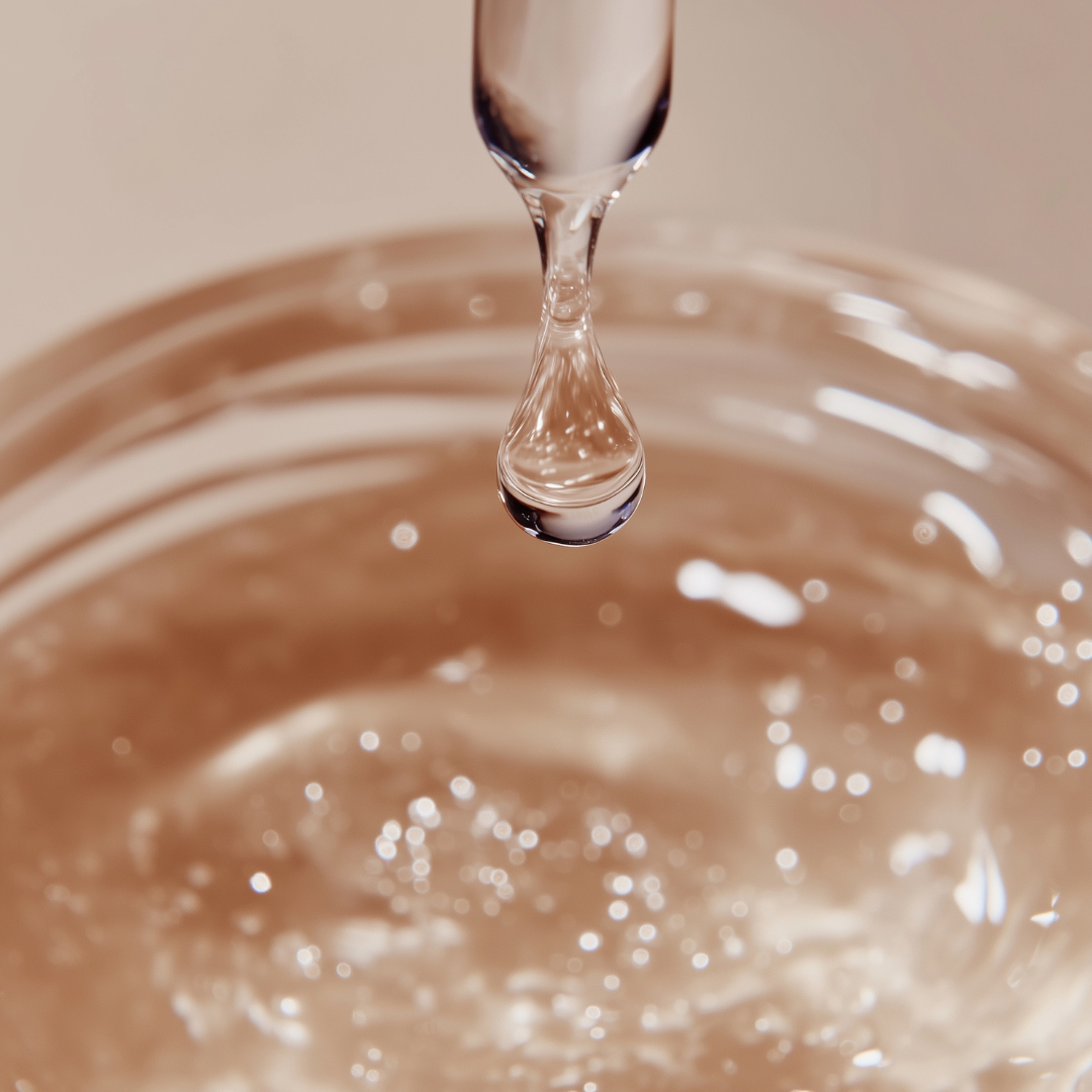 Dropper showing a drop of essential oil ready to fall into a glass