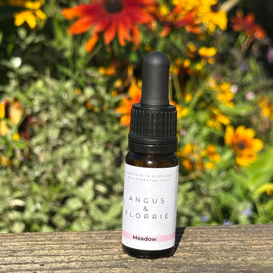 Meadow Essential Oil Blend with a background of flowers