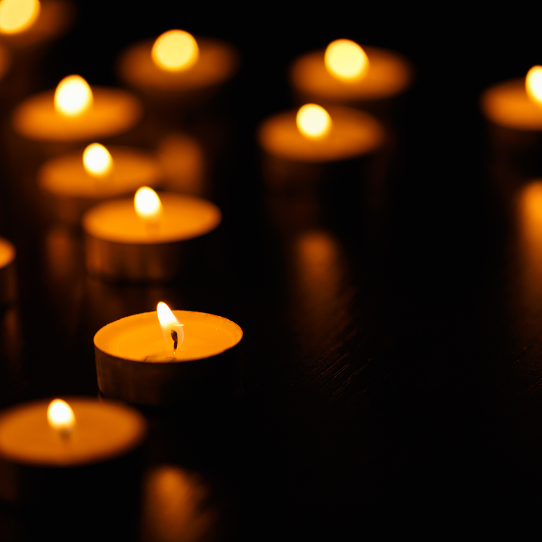 Tea lights lit on a dark background