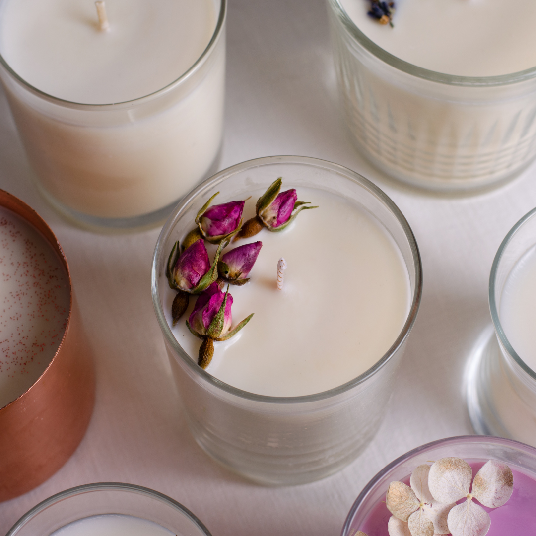 Group of candles with the central candle decorated with red rose buds