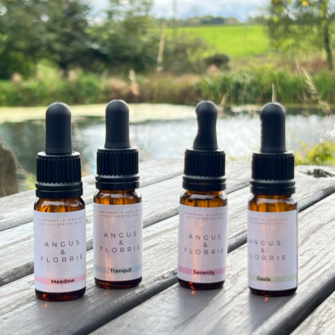 Four bottles of Angus &amp; Florrie products on a wooden surface with a natural background.