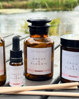 Collection of Angus & Florrie products on a wooden table with a scenic background