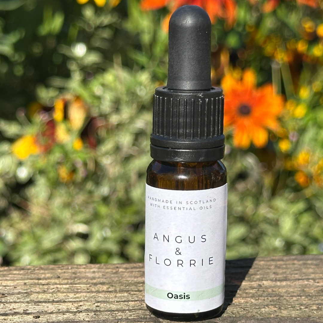 Bottle of Angus & Florrie essential oil with a natural background