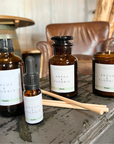 Collection of Angus & Florrie product bottles and a candle on a wooden surface.