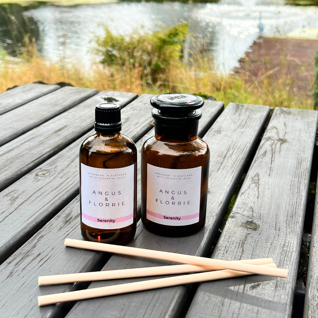 Two bottles of Angus & Florrie products on a wooden surface with a natural background