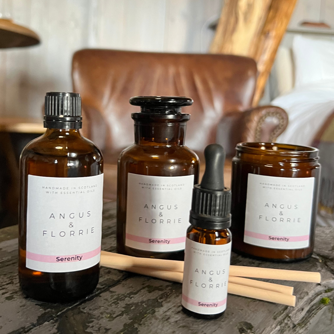 Collection of Angus & Florrie serenity products on a wooden surface with a blurred background.