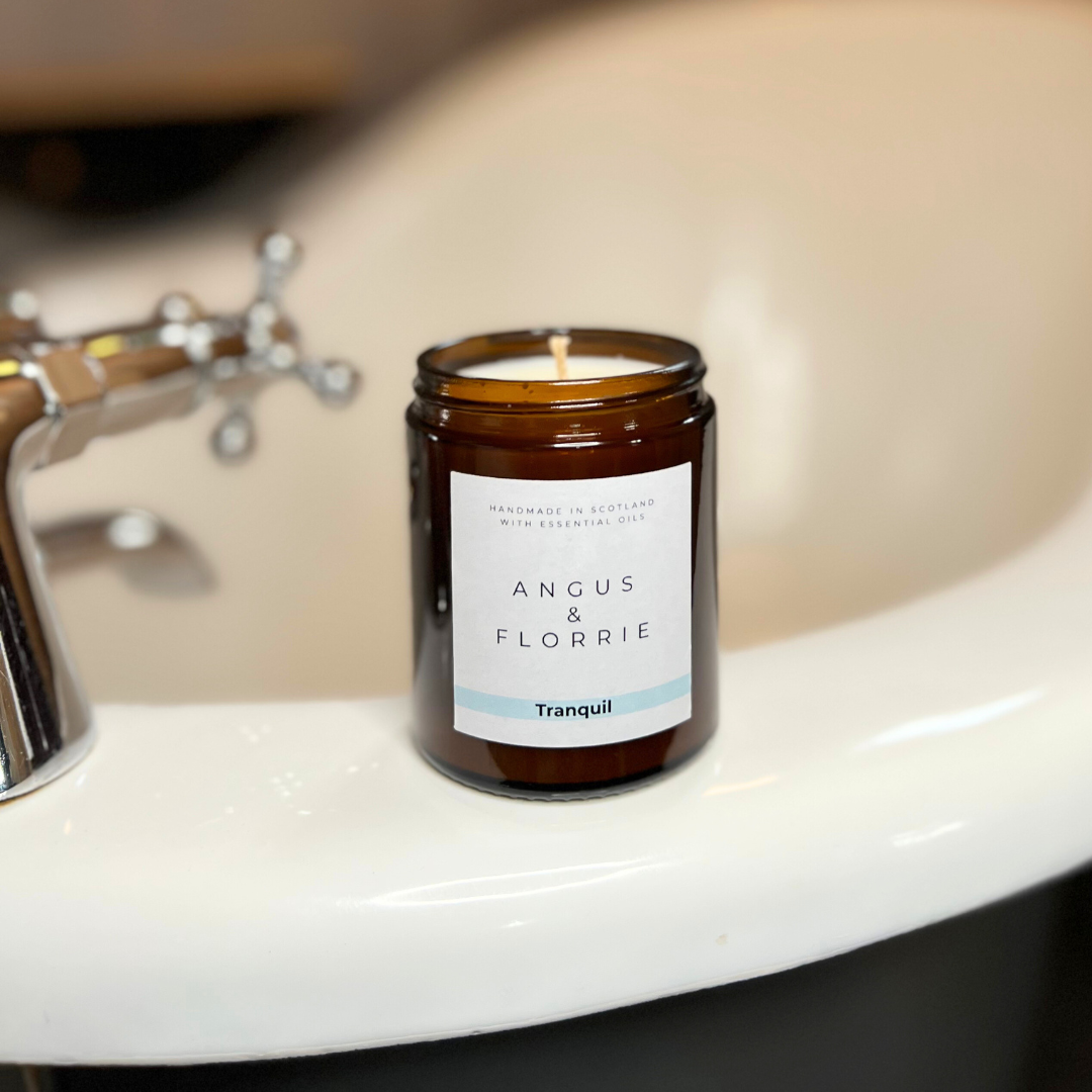 Candle labelled 'Angus & Florrie' on a bath
